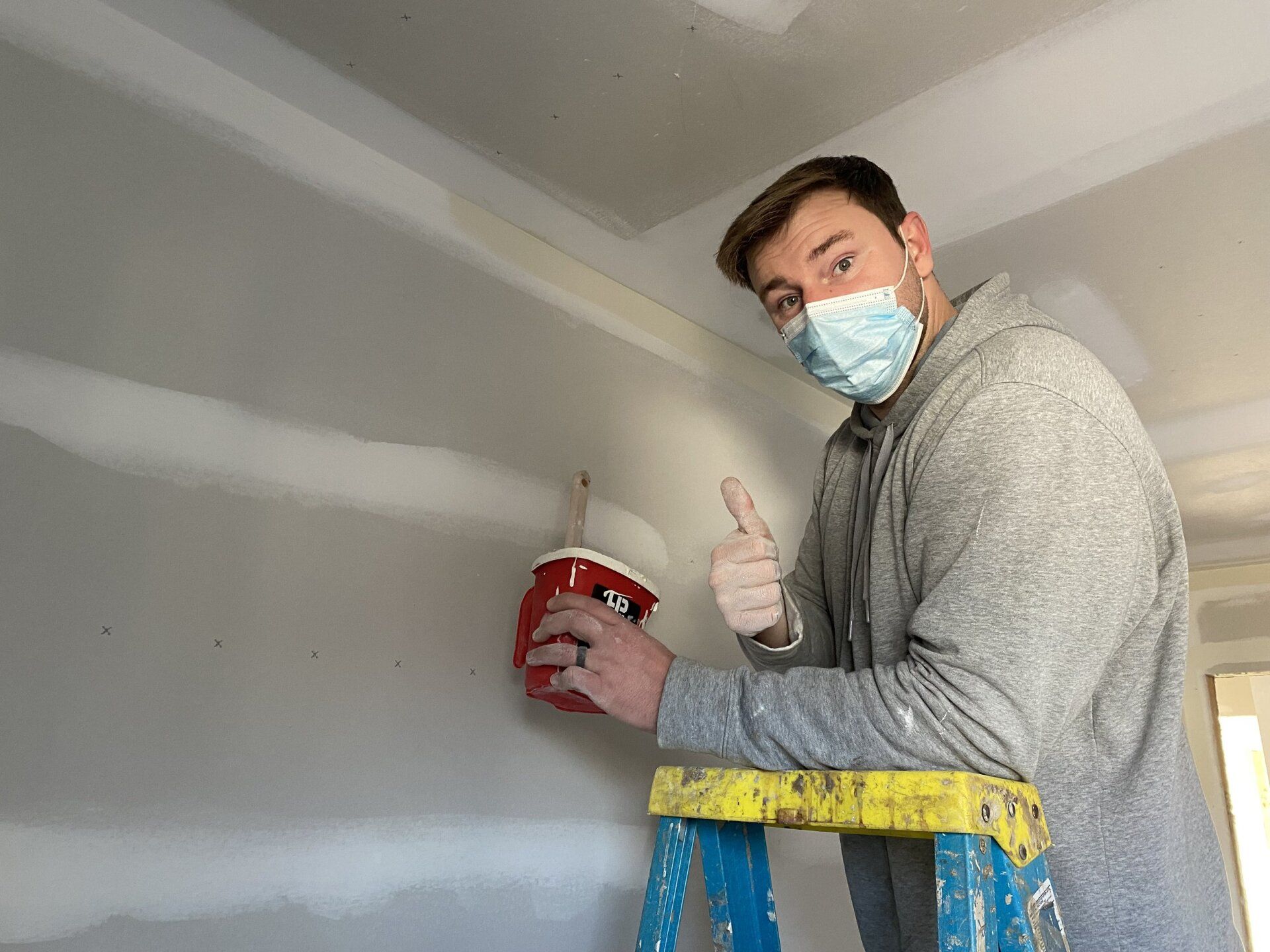 Image of RETEX's Josh Lewis volunteering by painting at Richmond Habitat for Humanity job site in January 2022.