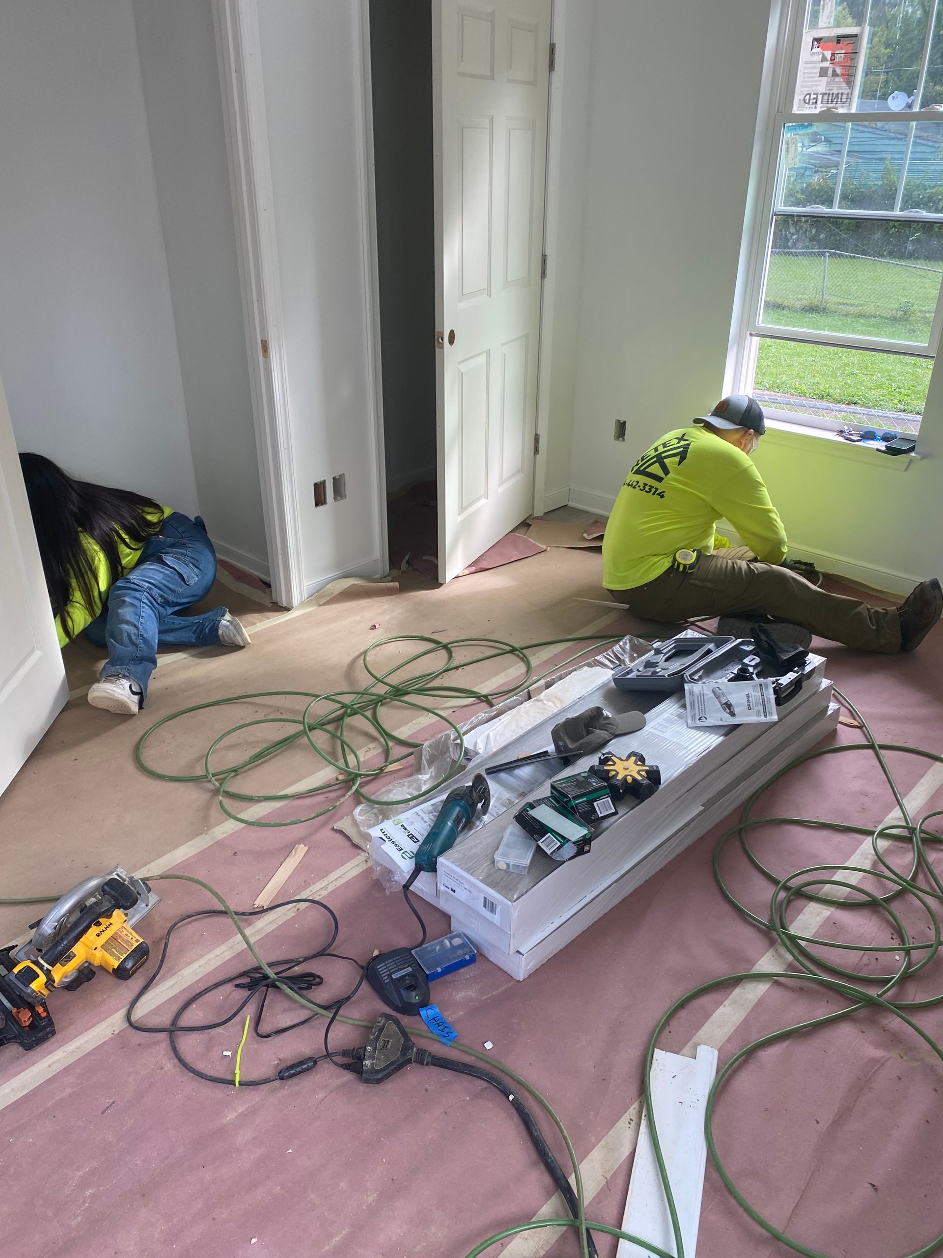 RETEX's Iris Hernandez and Chris Spahr install trim at a Richmond Habitat for Humanity home in September 2024.