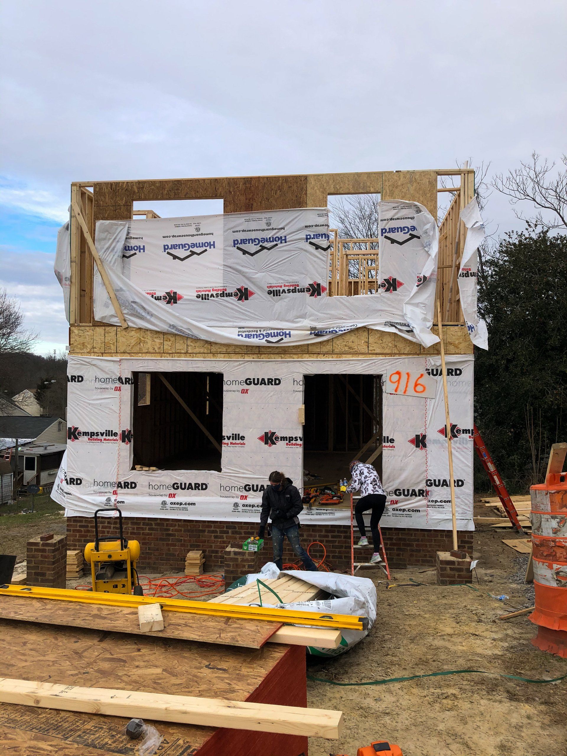 Image of RETEX's Katelyn Lewis entering a Richmond Habitat for Humanity build site during a volunteer day.