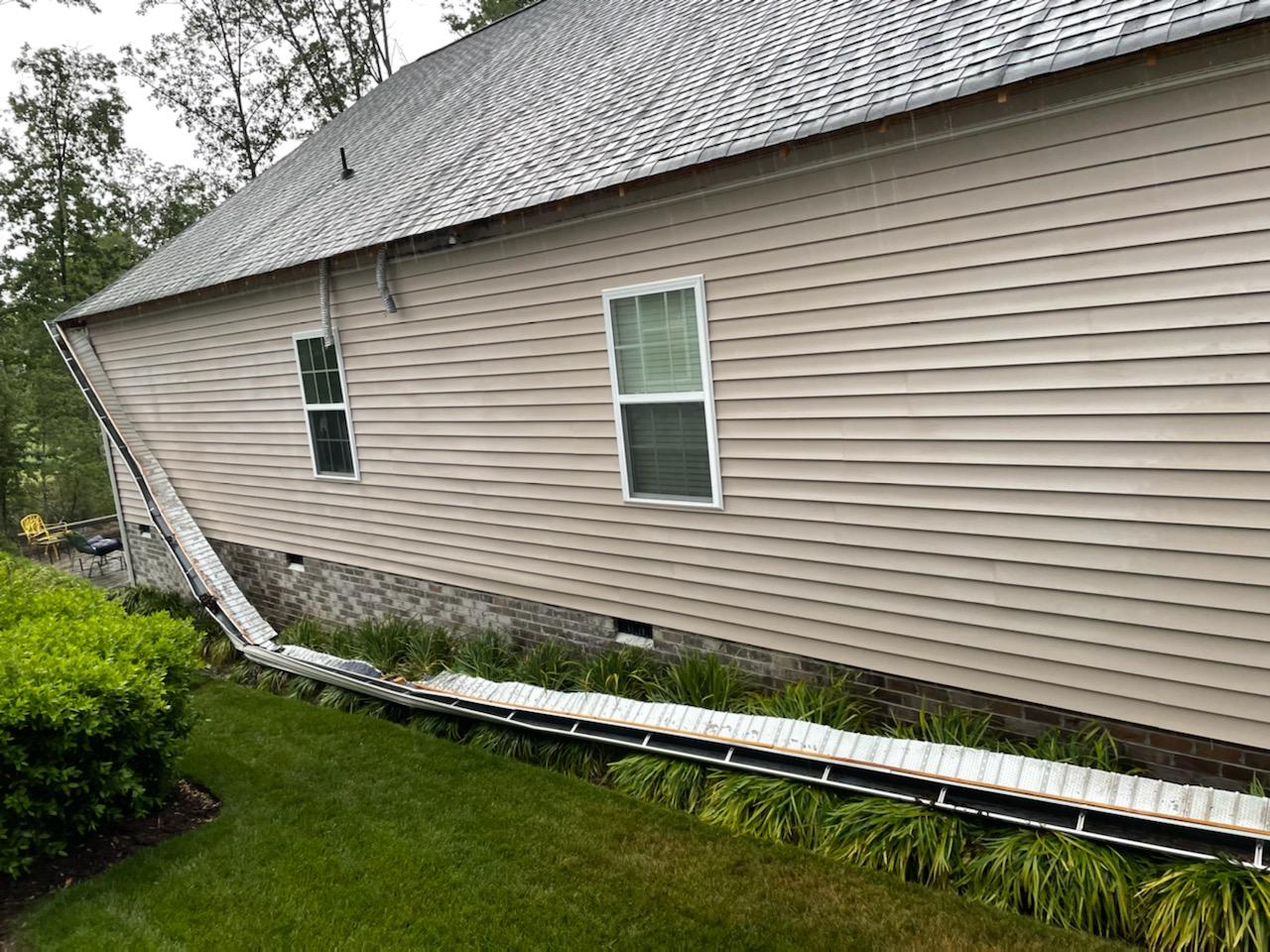 Image of full length of gutters pulled away from Richmond VA home. 
