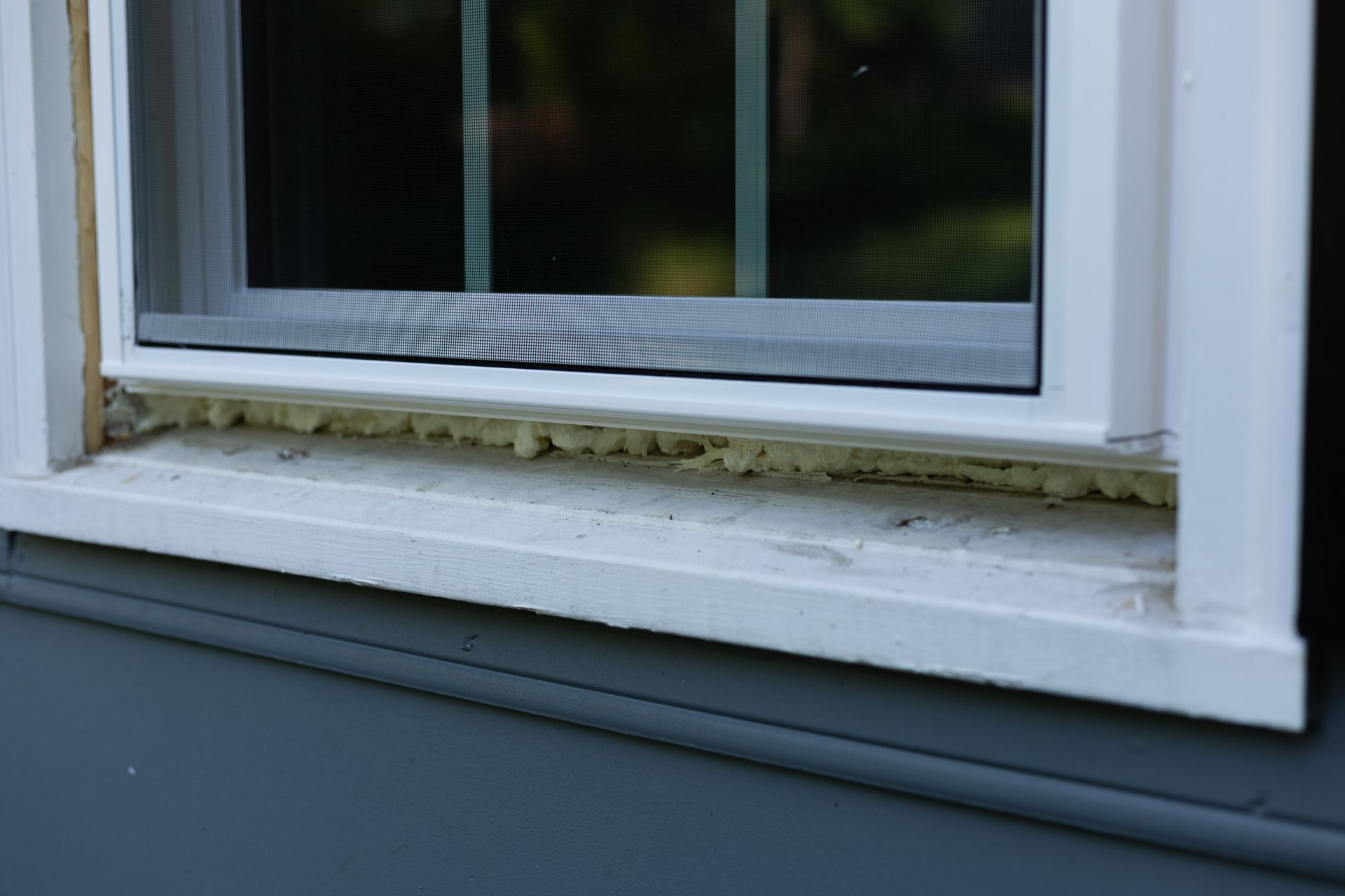 A during-install image of a RETEX window replacement in North Chesterfield VA. This image shows a close up of the spray foam.