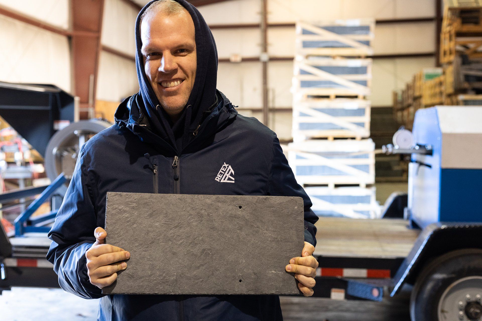 Image of RETEX's Mark Erickson hold in a piece of natural slate.