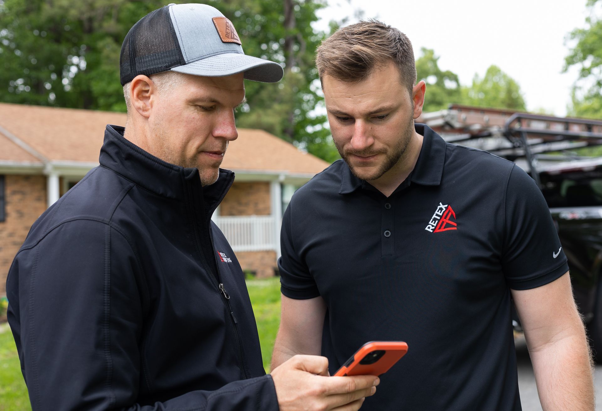 Image of RETEX's Mark Erickson discussing a quote on his phone with RETEX's Josh Lewis.