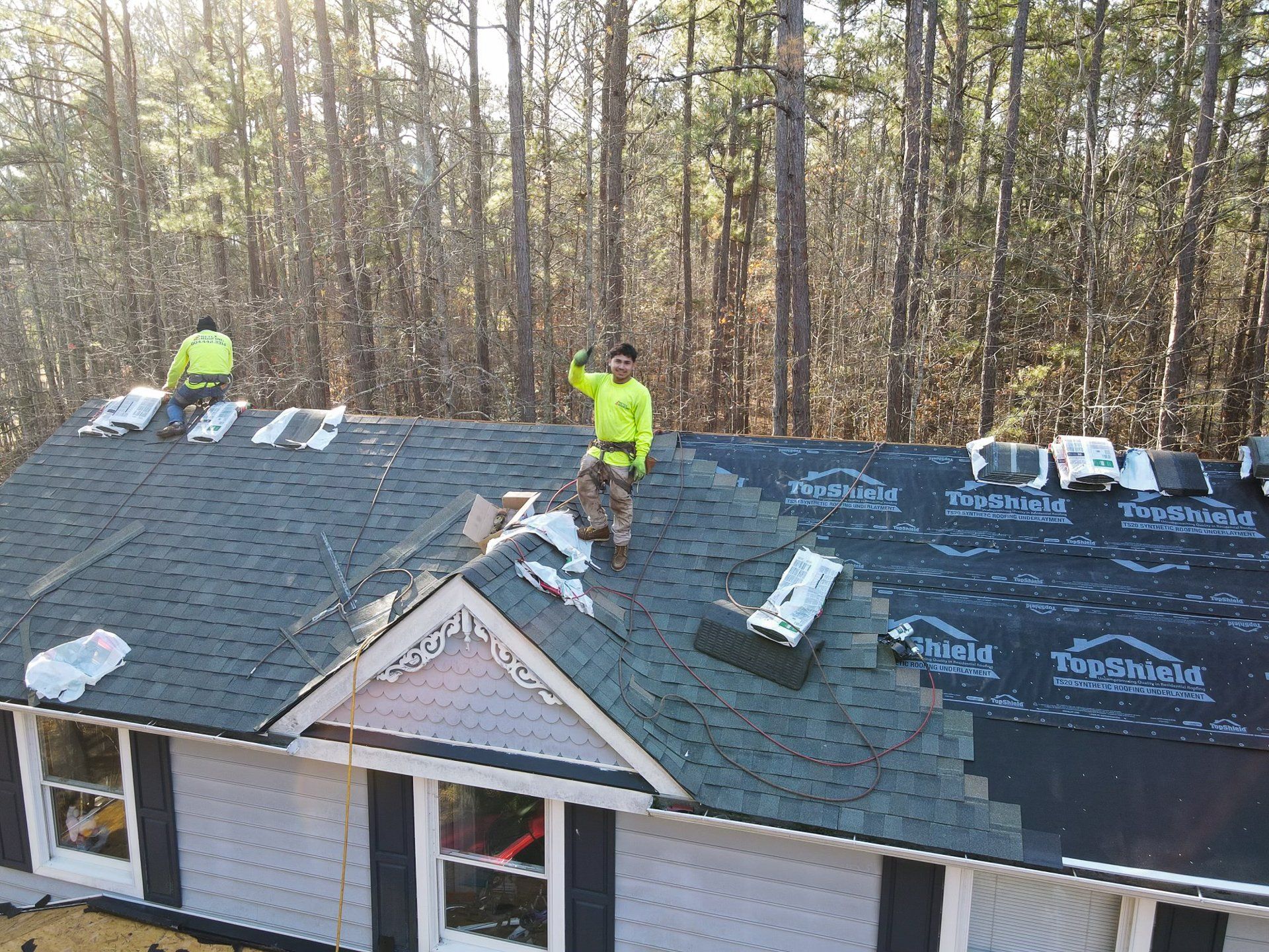 Drone image of RETEX's Freddie Brown waving at camera during RETEX roof installation in Moseley VA 23120.