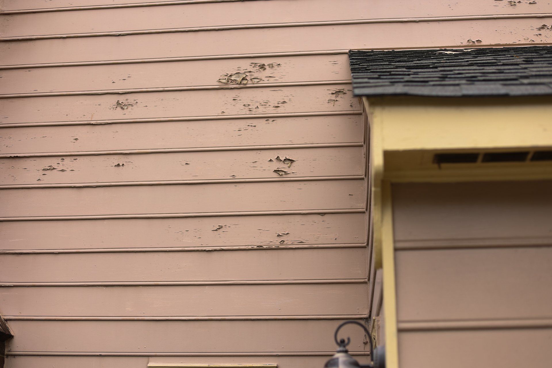 An image of damaged Masonite siding on a North Chesterfield VA home.