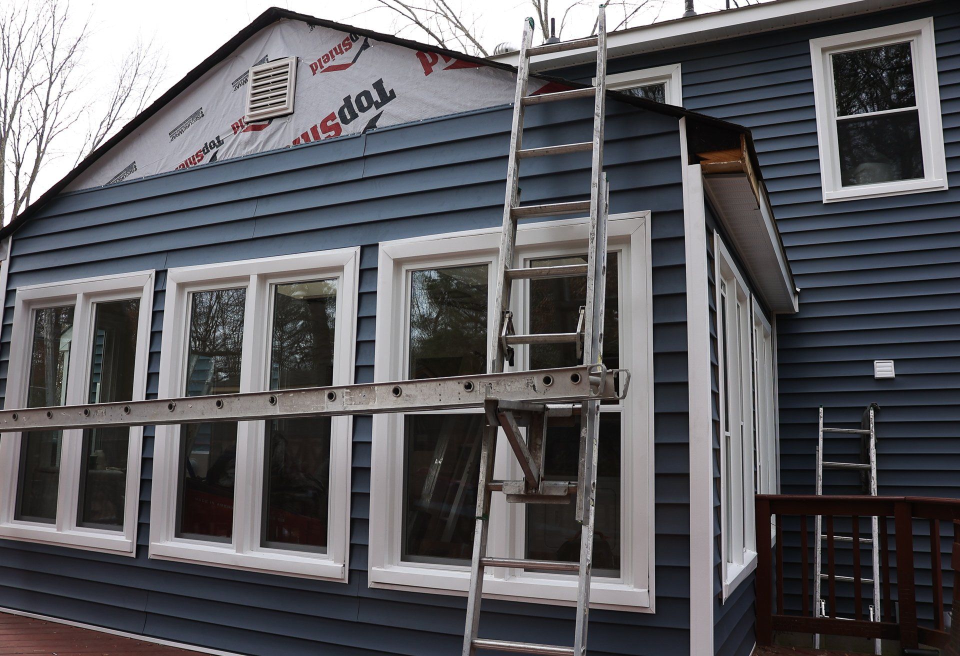 A during-installation photo of a RETEX vinyl siding replacement in North Chesterfield, VA 23235.