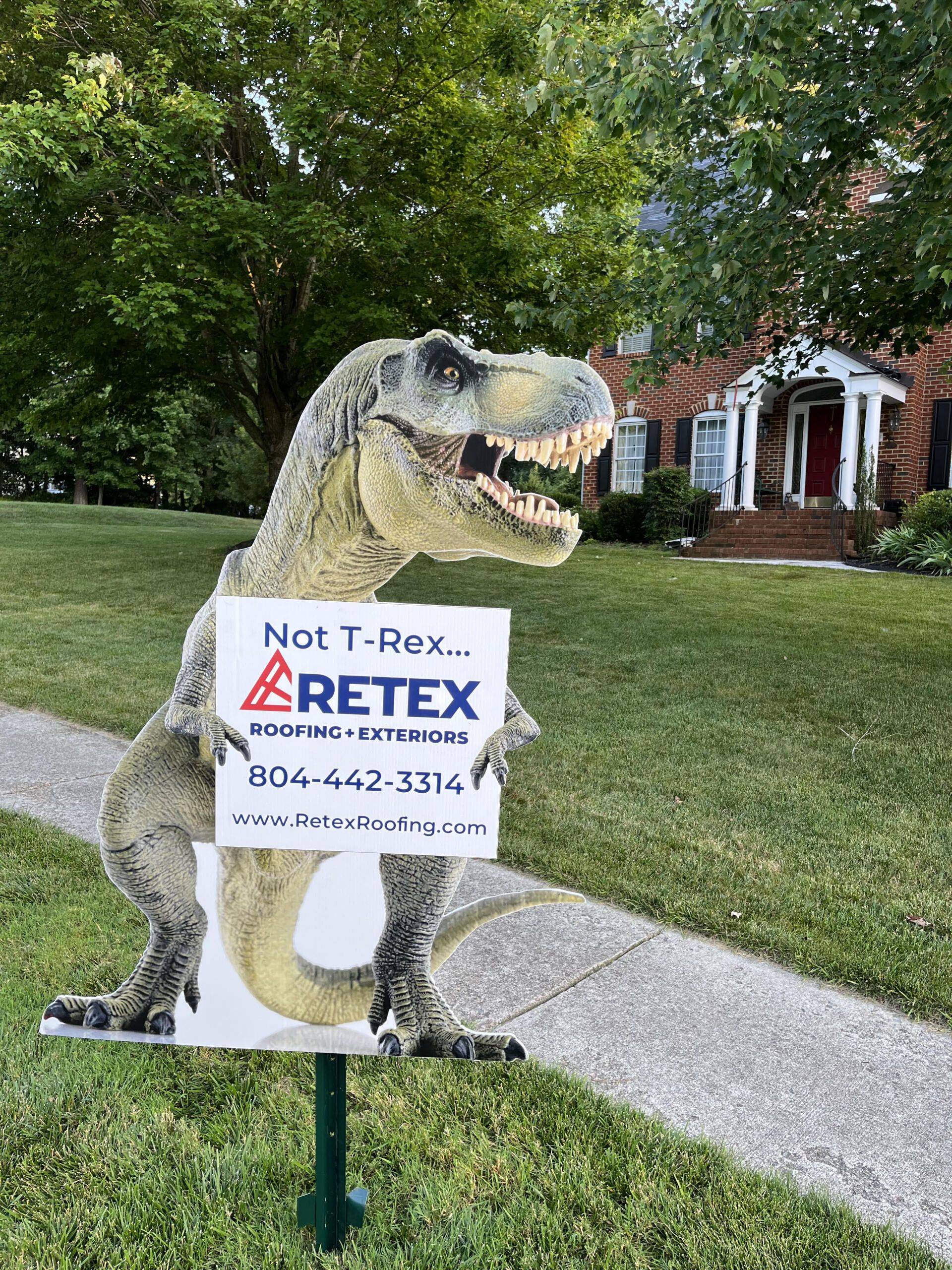 Image of RETEX dinosaur yard sign in Foxfire neighborhood of Moseley VA 23120.