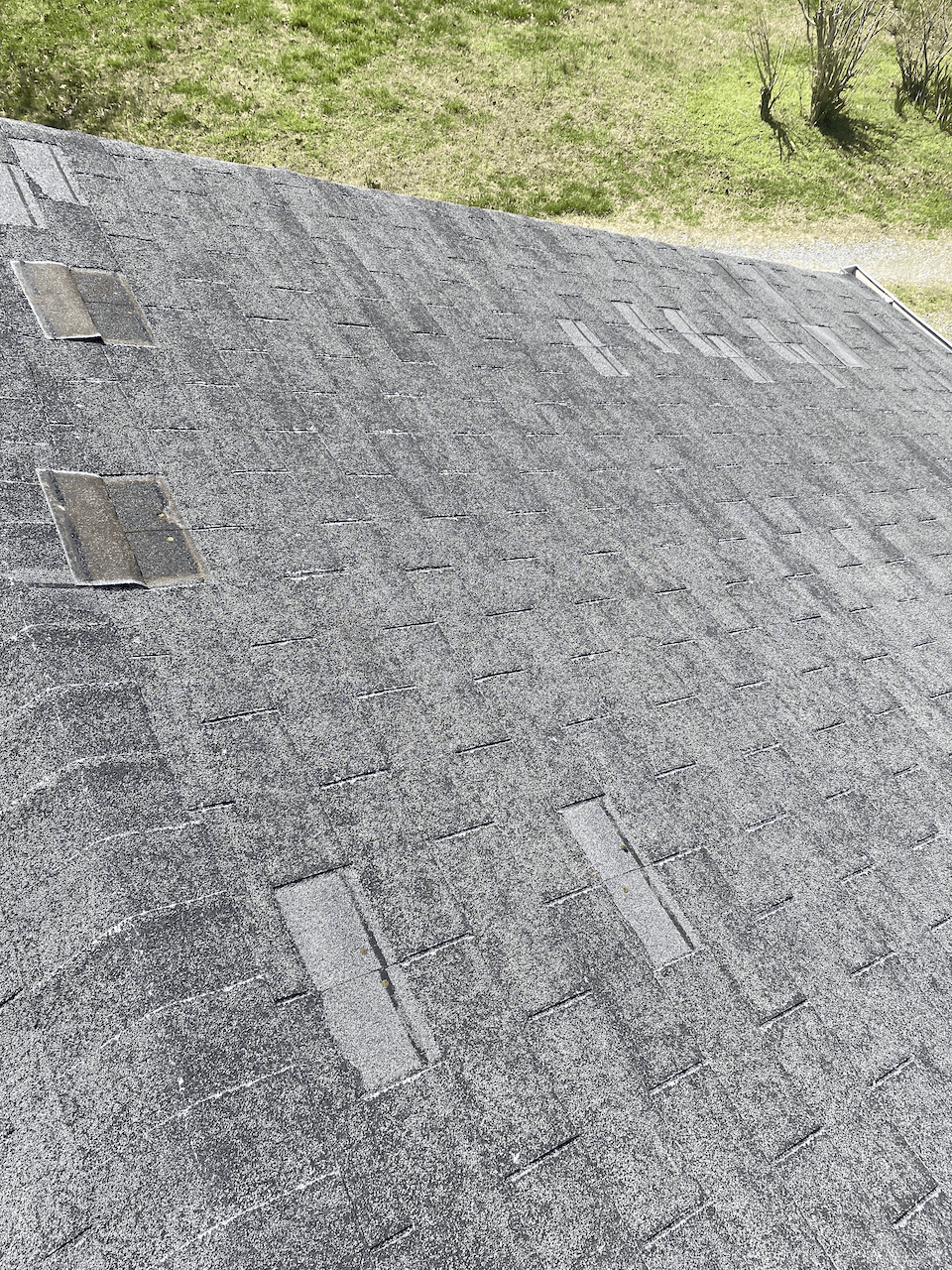 Image of old, wind-damaged roof in North Chesterfield VA 23235.