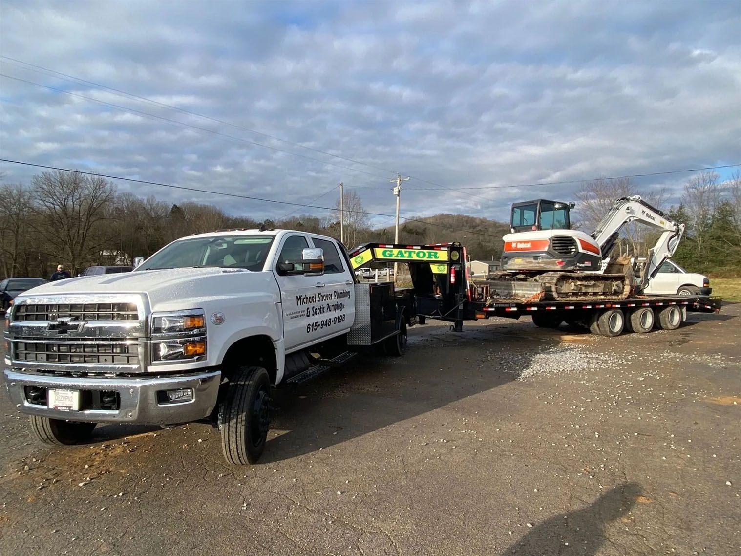 Company pick up truck in front of excavator — Bethpage, TN — Michael Shaver Plumbing & Septic Pumping