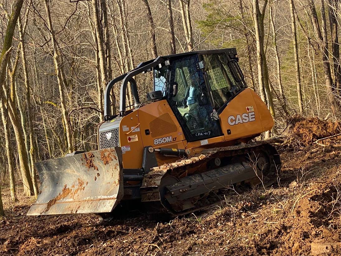 Bulldozer next to many trees — Bethpage, TN — Michael Shaver Plumbing & Septic Pumping