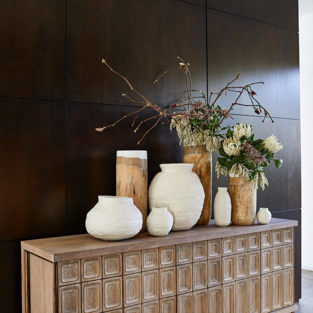 Wood paneled walls with a retro console table
