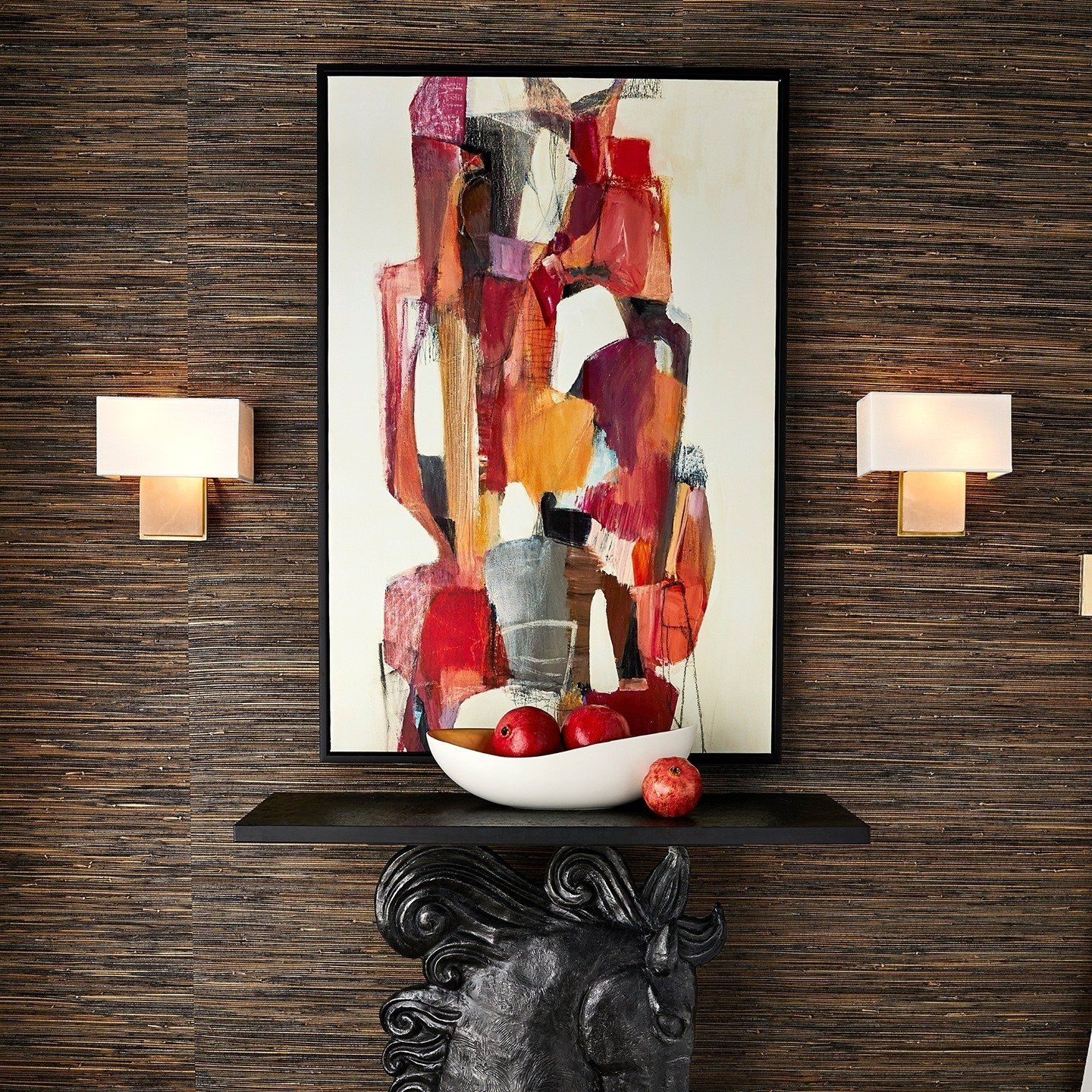 Retro abstract art brings pops or orange and red to this chic room