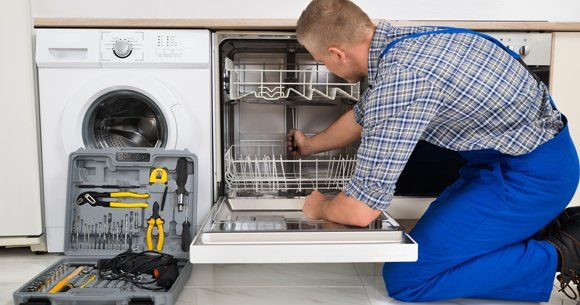 Home Appliance Repair — Man Repairing Dishwasher in Indianapolis, IN