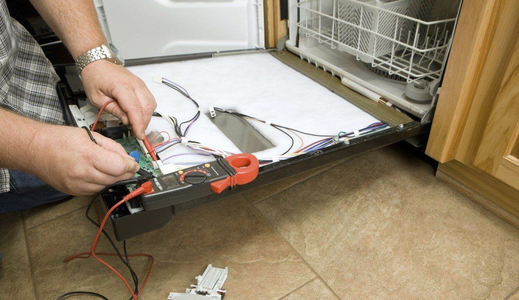 Home Appliance Repair — Man Repairing Dishwasher in Indianapolis, IN