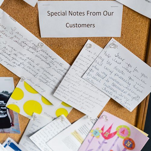 A cork board with special notes from our customers on it