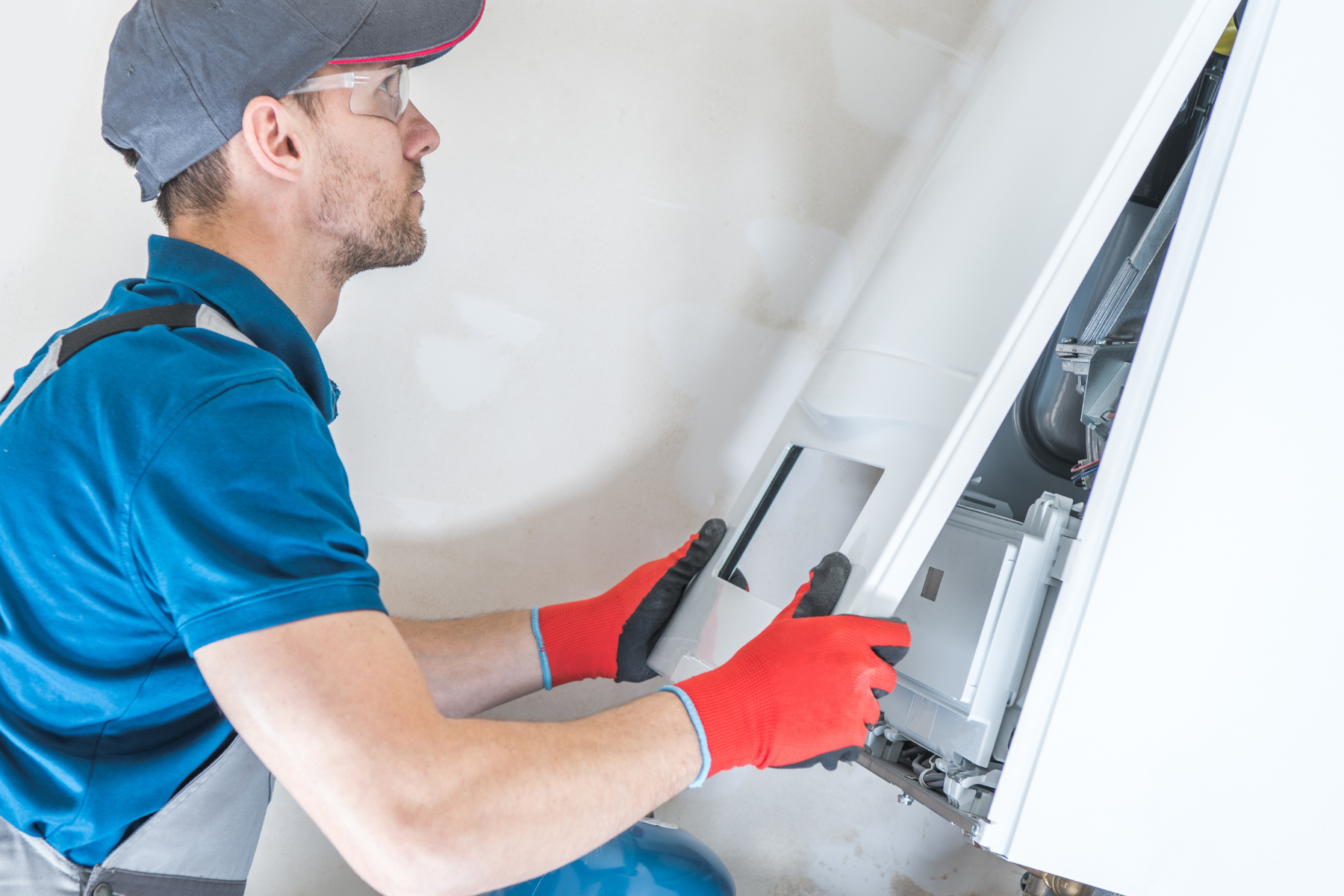 A man is working on a furnace | heating and air services central arkansas