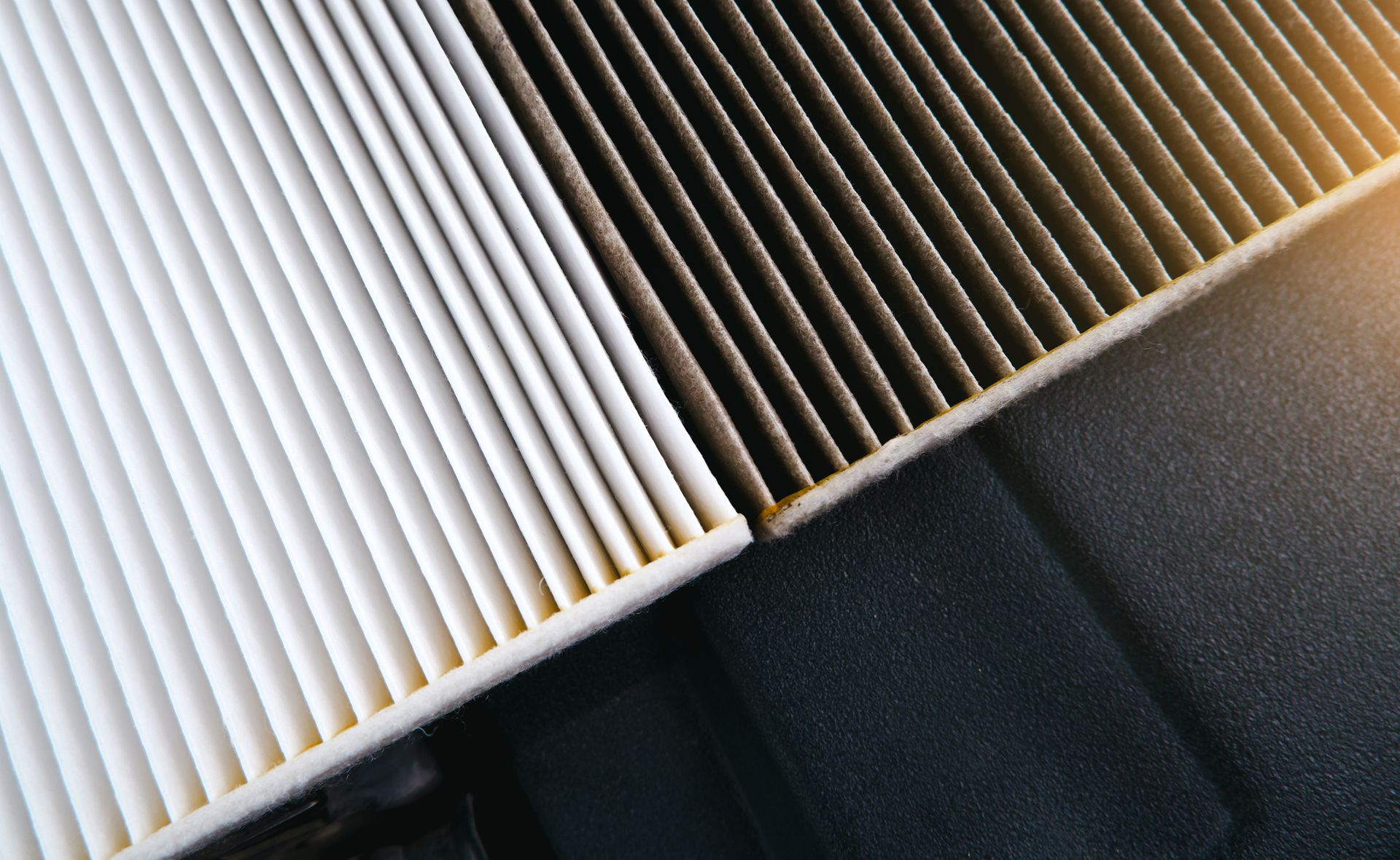 a close up of a dirty and clean air filter