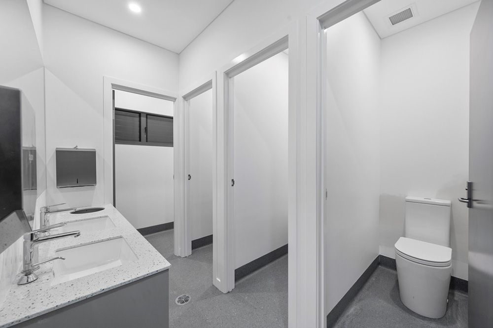White Bathroom Stalls — Award-Winning Builders in Townsville, QLD