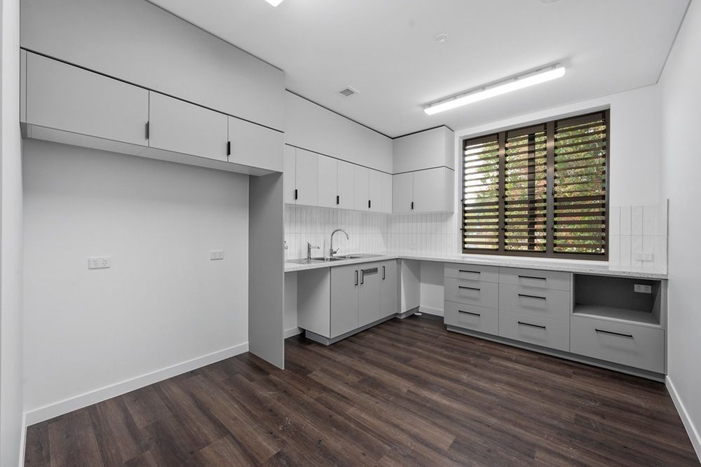 Kitchen With White Cabinets — Award-Winning Builders in Townsville, QLD