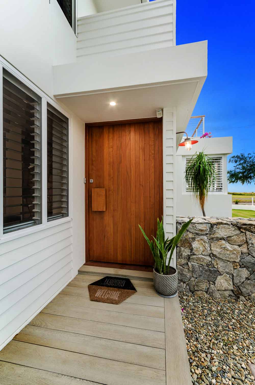 Pallarenda Beach House Wooden Entrance Door — Award-Winning Builders in Townsville, QLD
