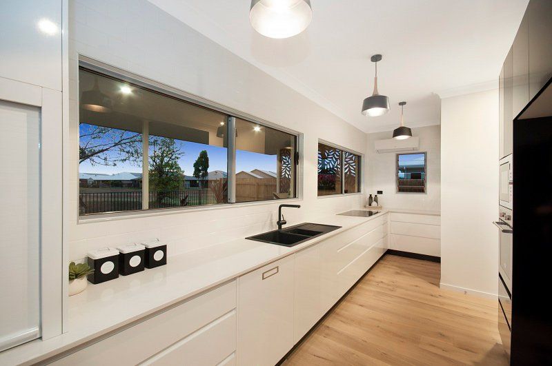 Fairways House with Nature View on the window — Award-Winning Builders in Townsville, QLD