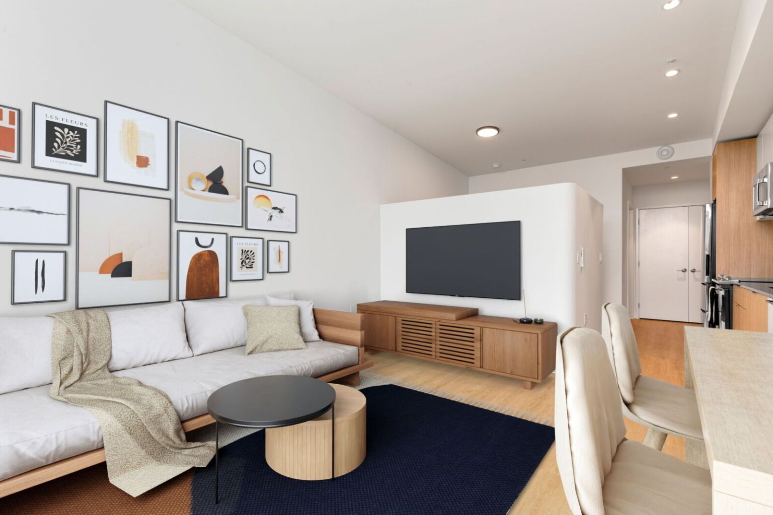 Living room with a sofa, TV, gallery wall, and a dark blue rug.