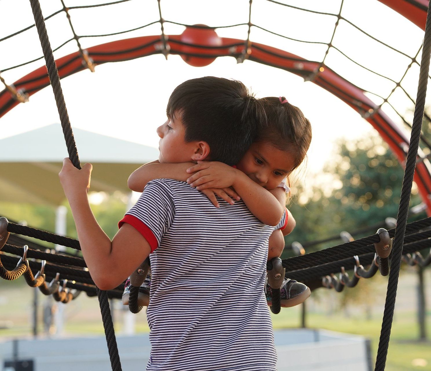 Brother and sister CASA kids hugging
