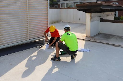 CD Strong Construction employees working on a roof