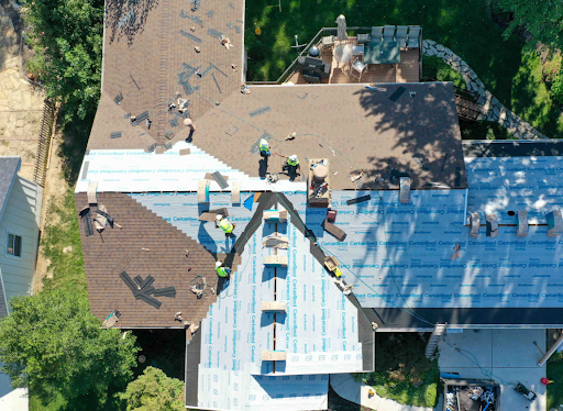 Aerial shot of a CD Construction crew working on a roof