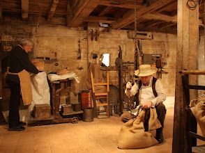 A man in a cowboy hat is holding a bag in a room.