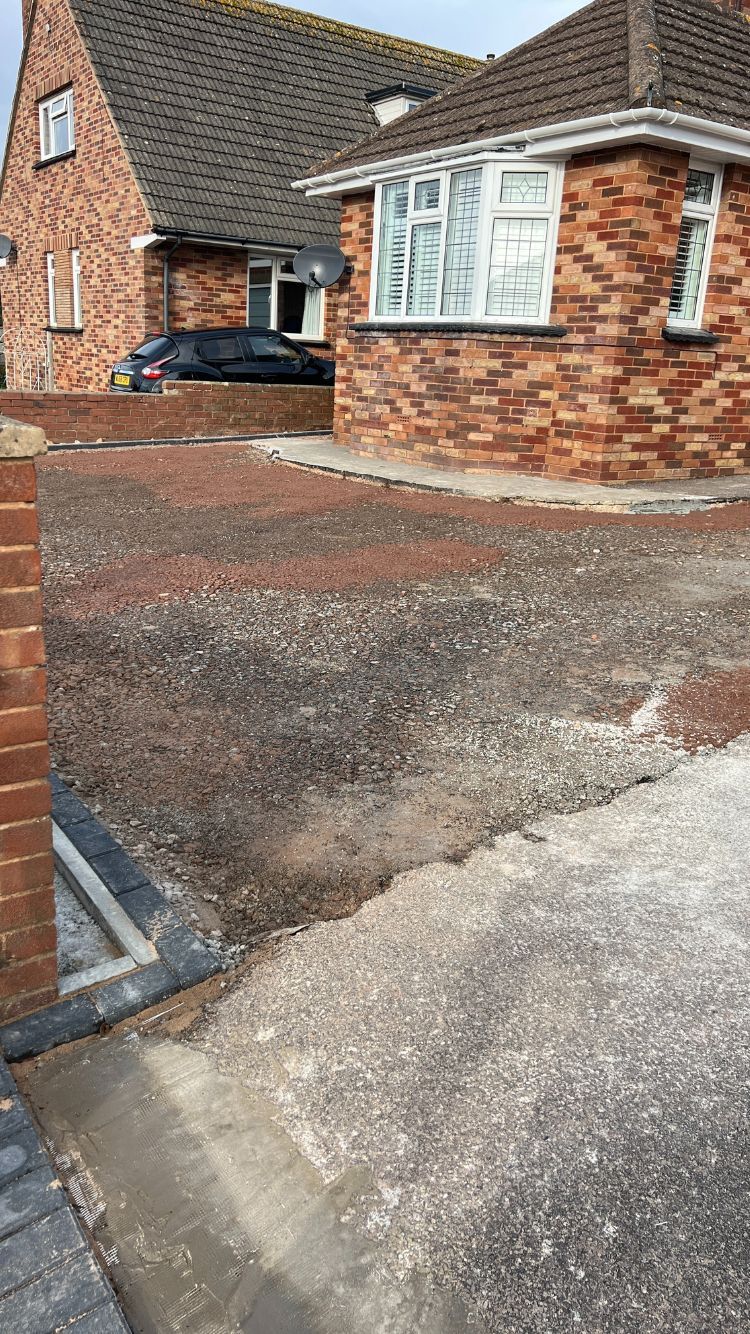 A photo of a driveway after it has been dug up