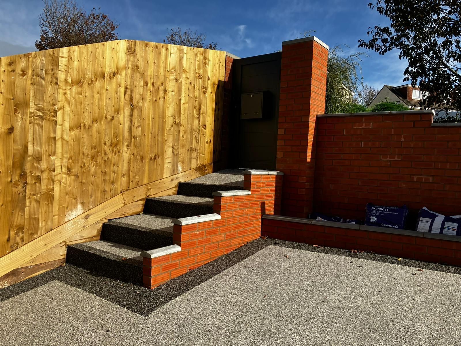 Resin steps leading down to grey resin patio