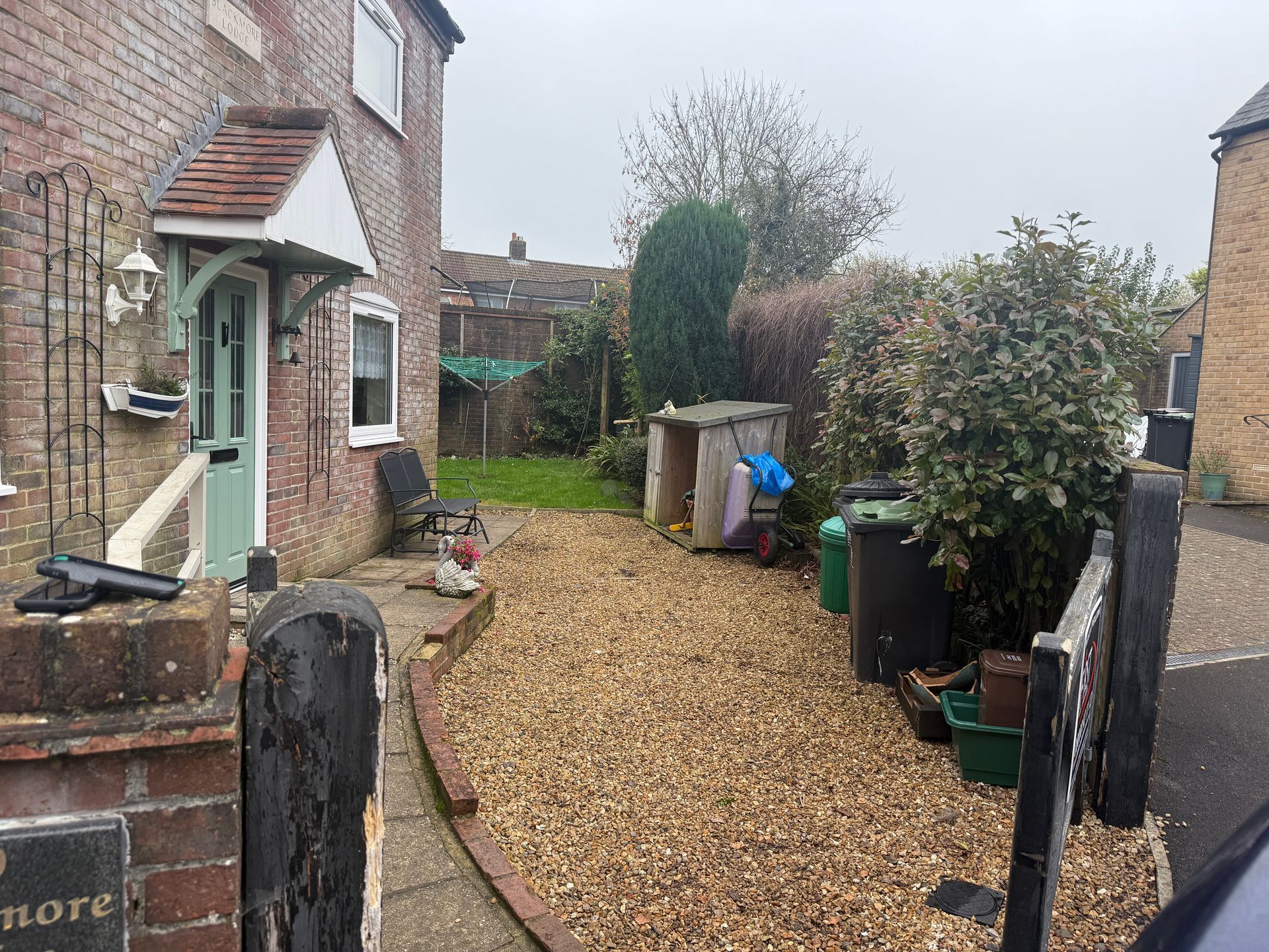 Before and after of downhill red resin driveway