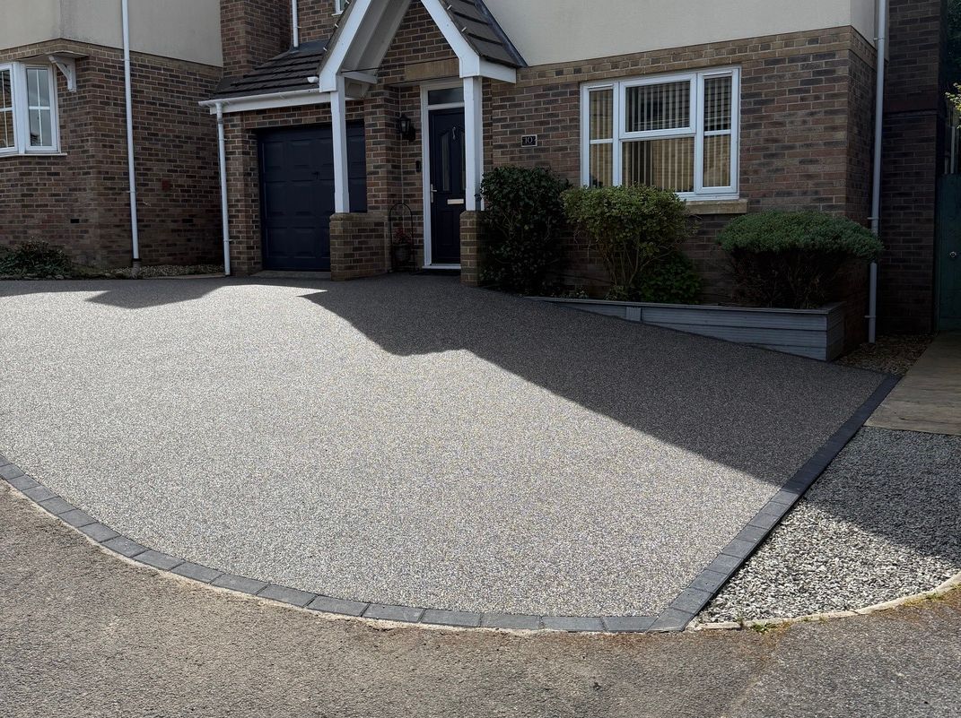 Close up of compass pattern on a grey resin driveway