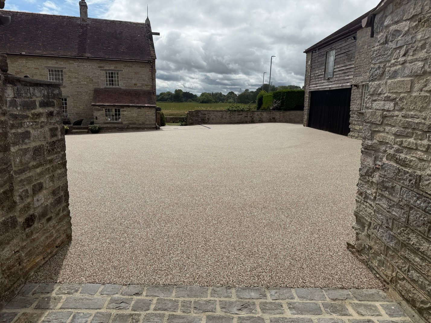Grey resin driveway with light grey resin and dark grey block paving borders