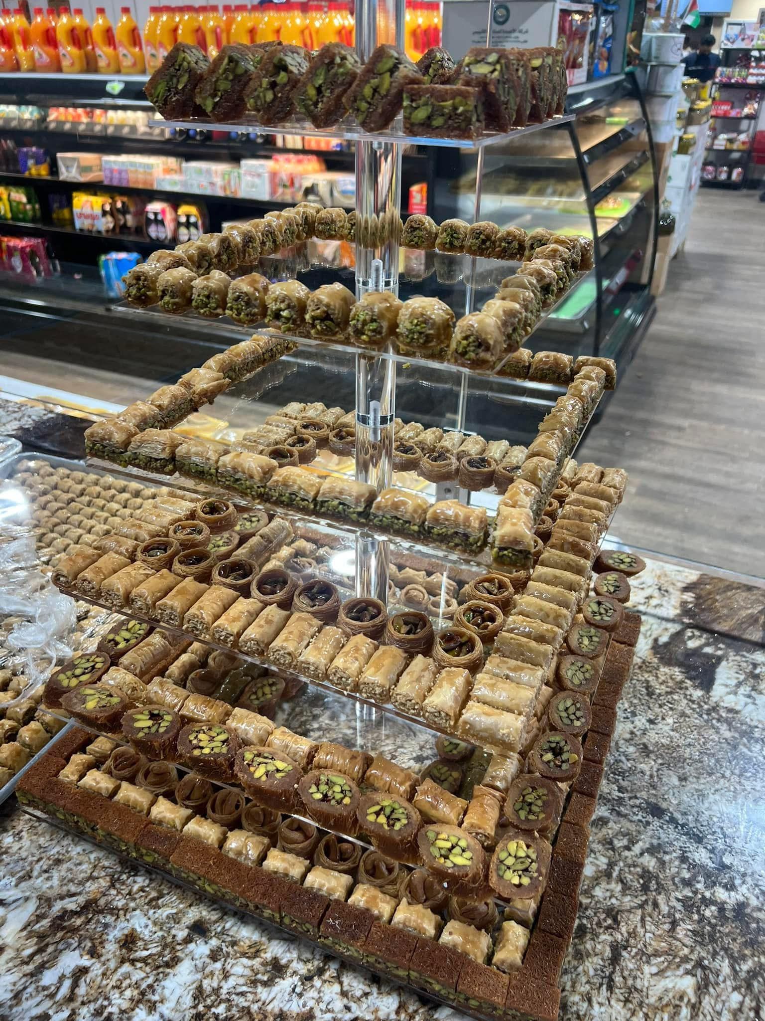 A display of baklava is sitting on a counter in a bakery.