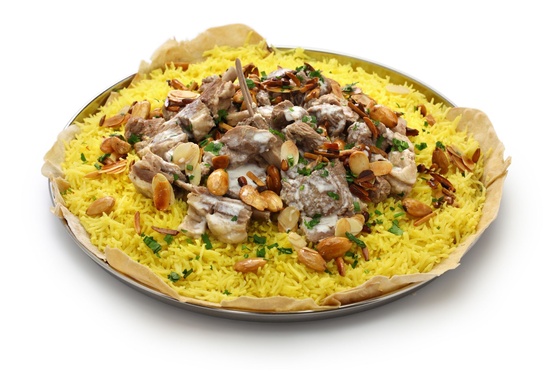 Yellow rice dish topped with meat, nuts, and sauce.