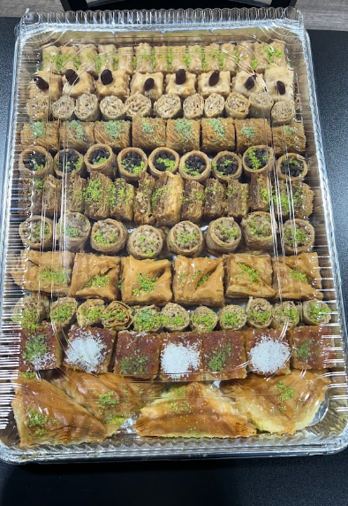A tray of baklava is sitting on a table.