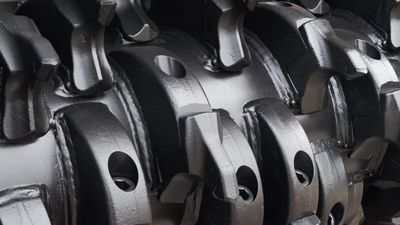 A close up of a metal object with holes in it.