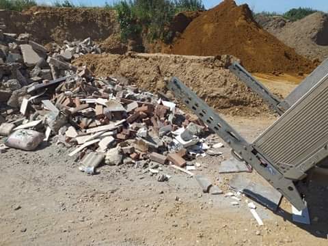 Building waste and rubble being unloaded from the van