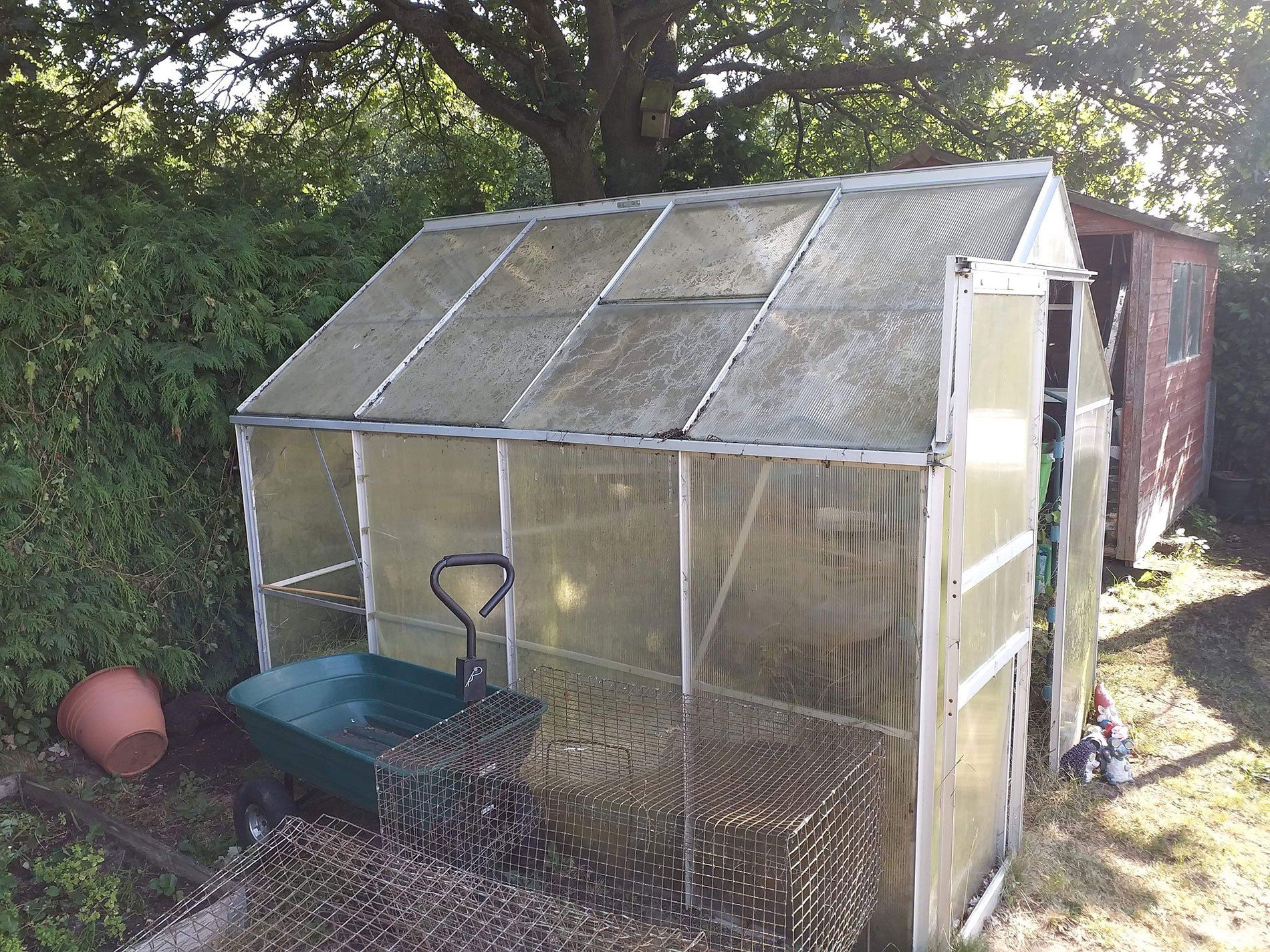 greenhouse ready to be dismantled part of a garden clearance