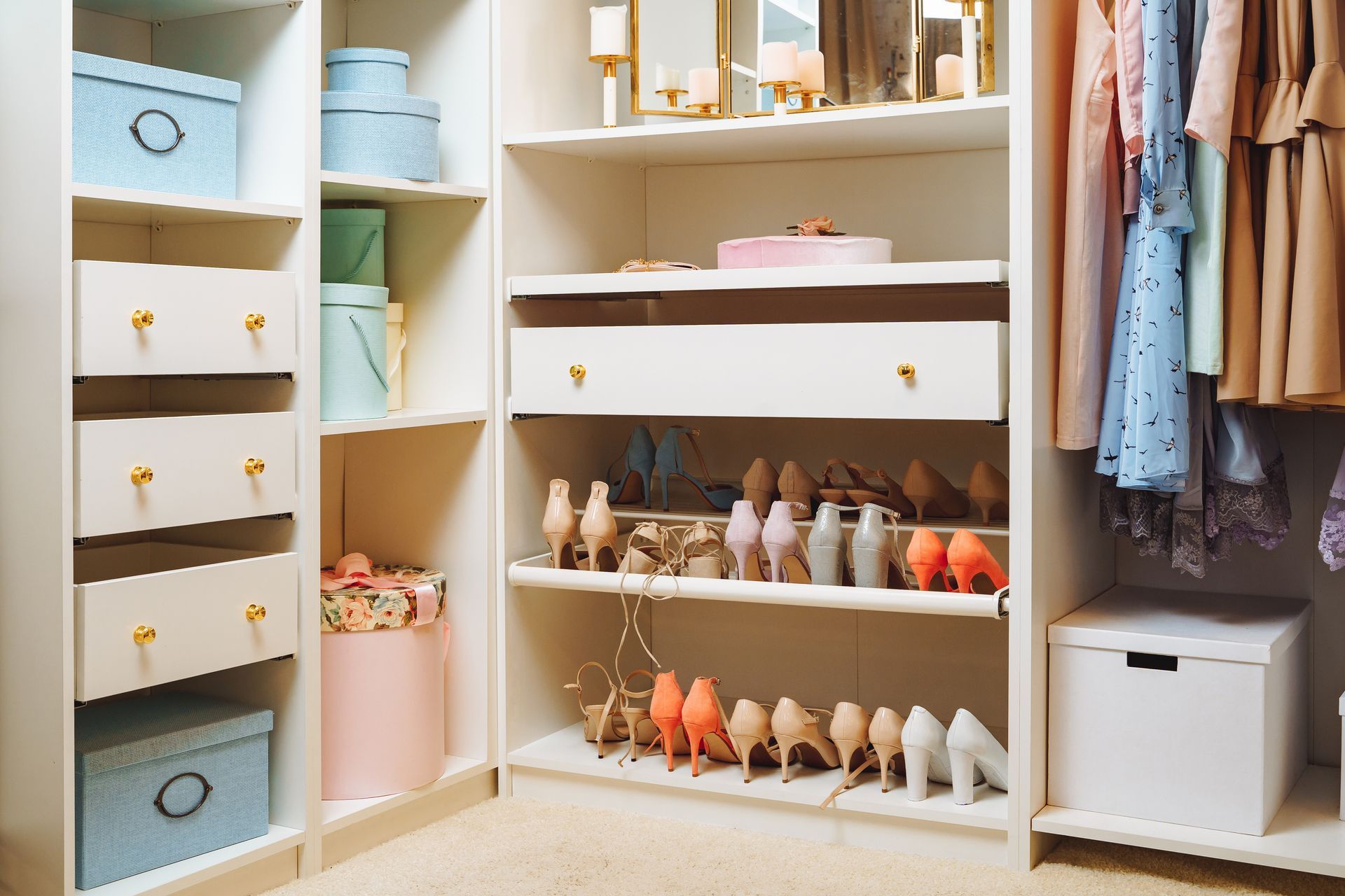 Open closet with shelves, drawers, hanging clothes, and neatly arranged shoes and storage bins