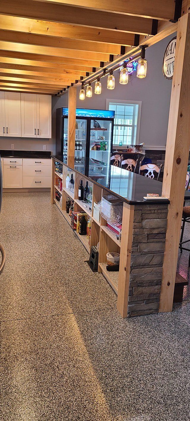 A large room with a lot of shelves and a refrigerator.