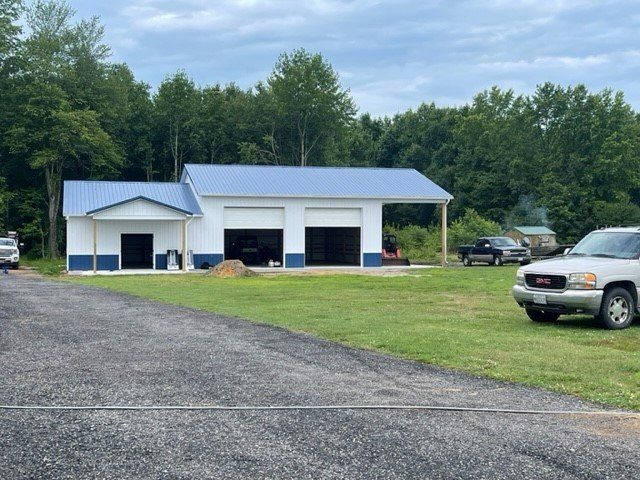 A gm truck is parked in front of a garage