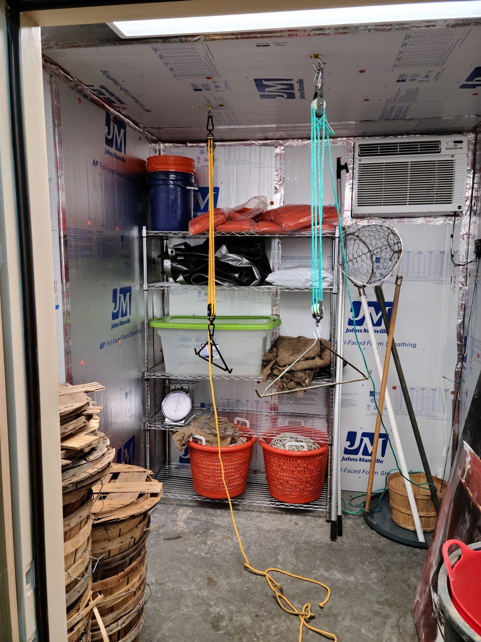 A room with a lot of shelves and baskets in it