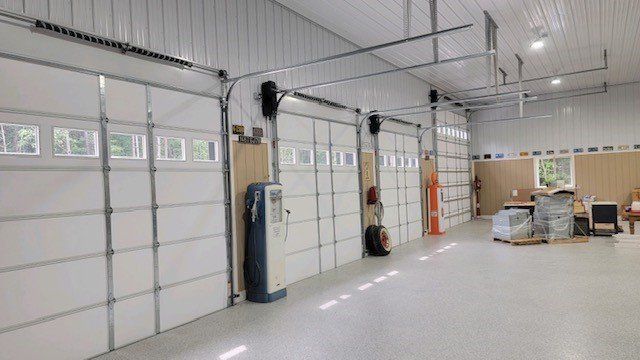 A large garage with a lot of white garage doors.