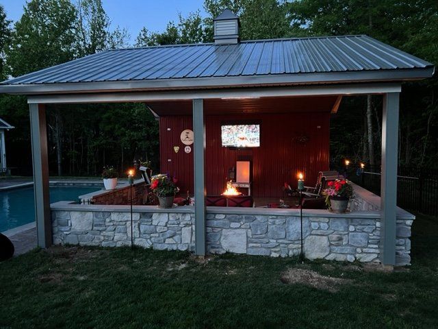 A house with a covered porch and a swimming pool in the background