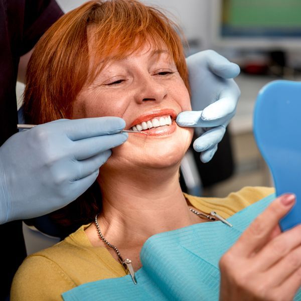Senior Woman with New Dentures — Paddington, QLD — Essential Dental Group