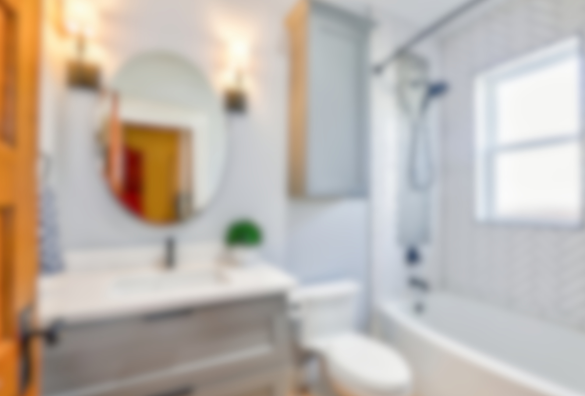 A bathroom with a sink , toilet , tub and mirror.