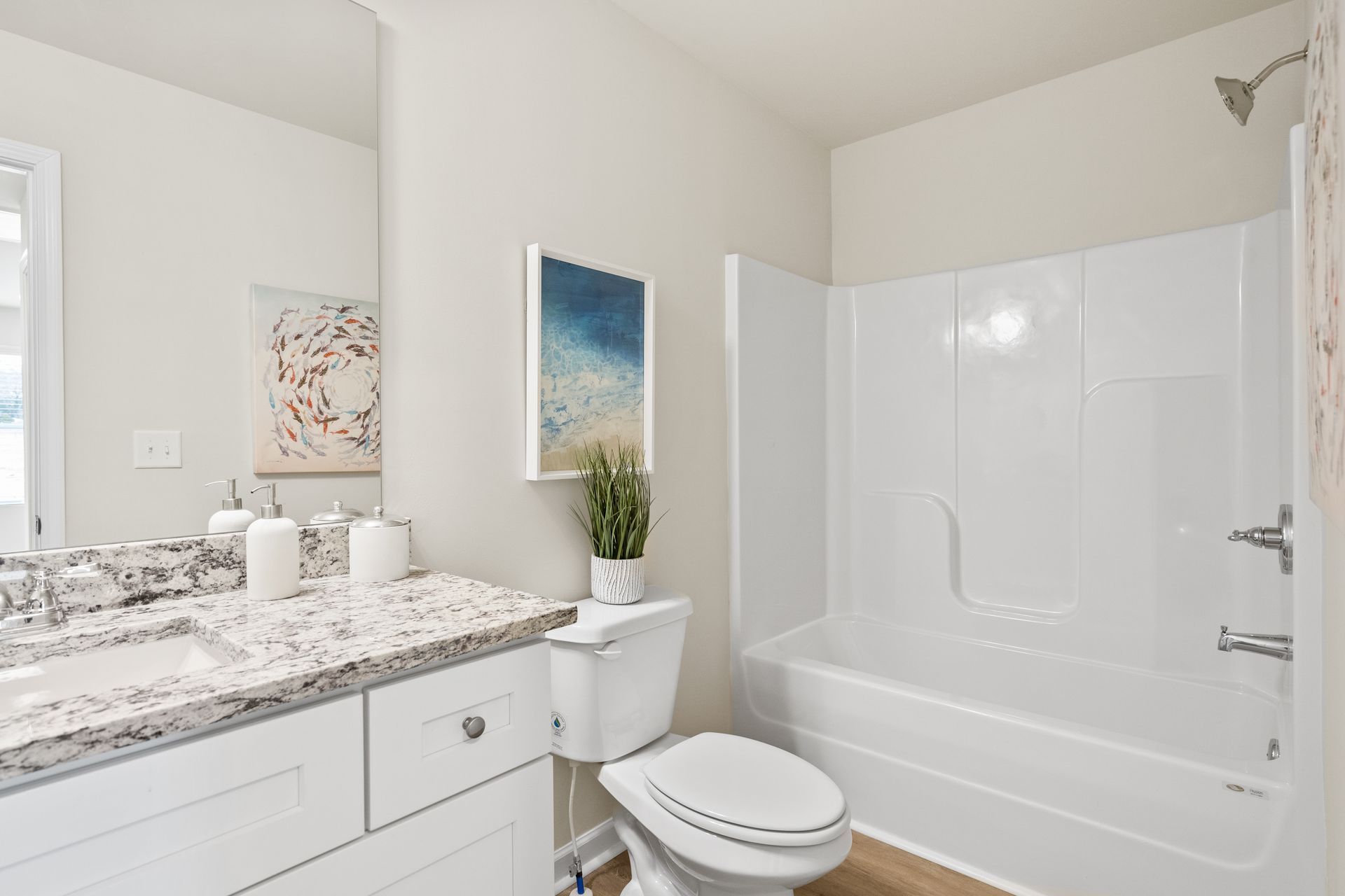 A bathroom with a toilet , sink , and bathtub.